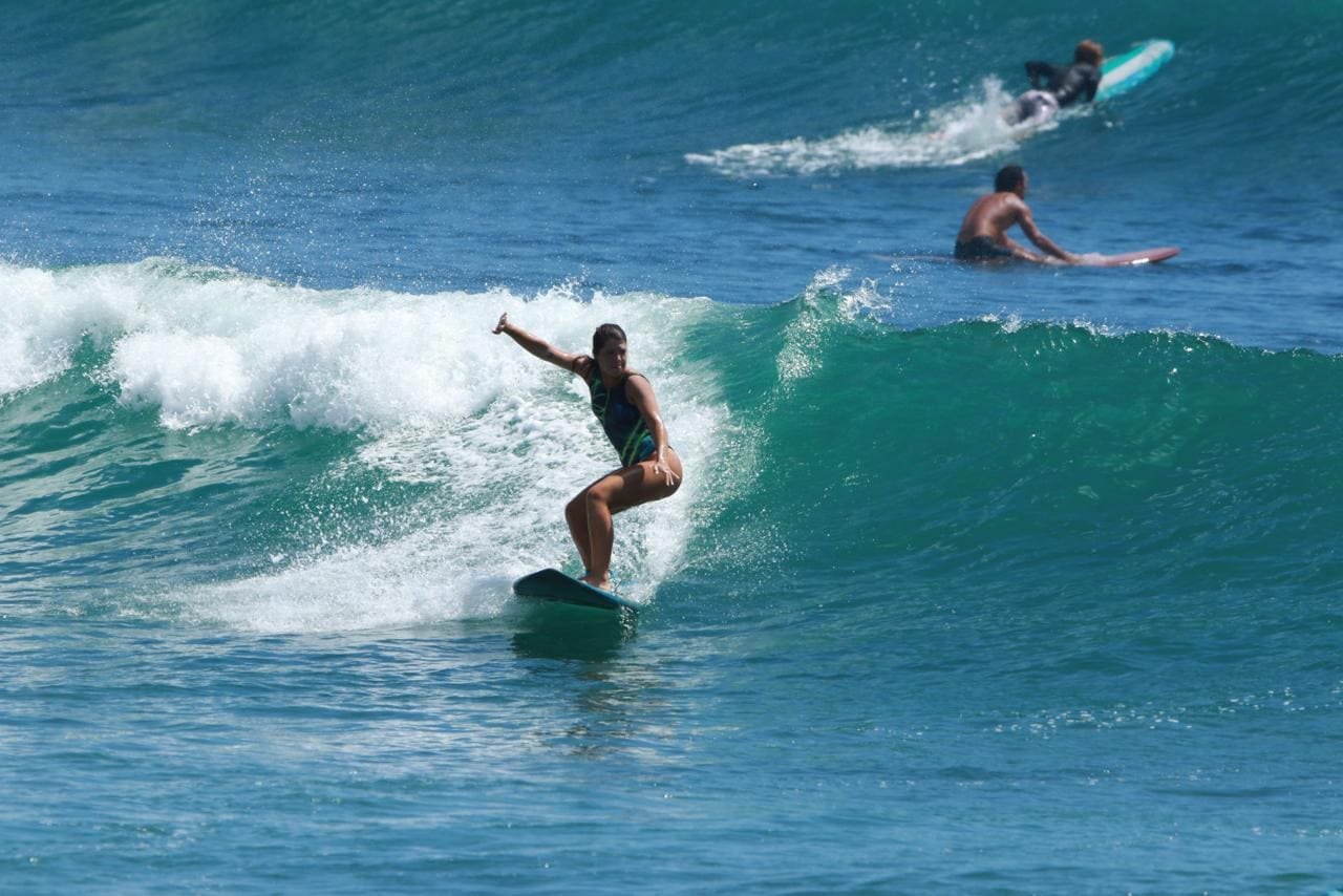 Intermediate surfer receiving local coaching in South Bali