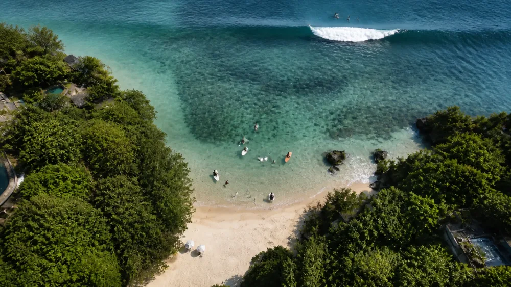 Aerial view showing sheltered Baby Padang and the powerful main Padang Padang reef wave